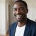 a happy black man customer at home passport photo